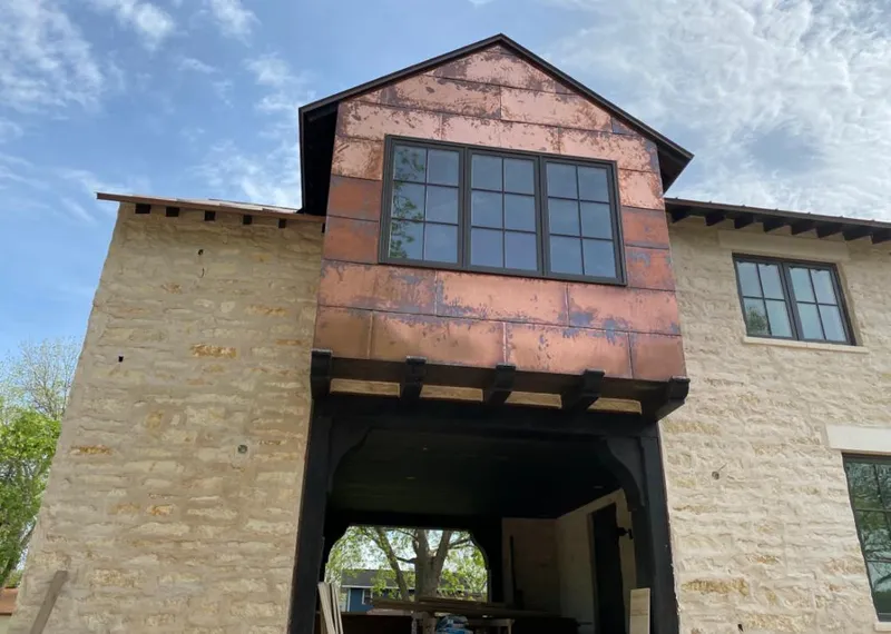 Copper metal panel facade on a stone building for Skylight Installation in Bull Mountain