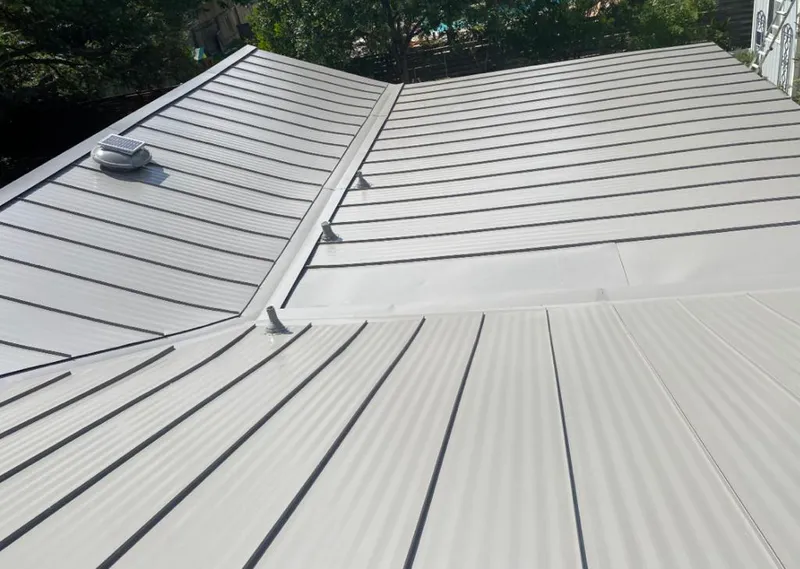 Solar attic fan installed on a metal roof for Roof Ventilation in Bull Mountain